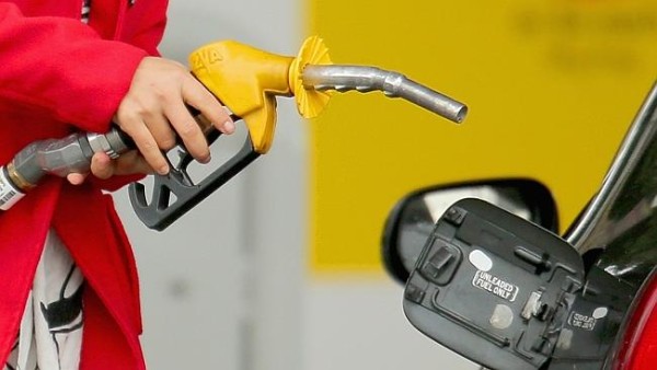MELBOURNE, AUSTRALIA - JULY 23: A woman uses a fuel dispenser to fill her car up with petrol at a petrol station on July 23, 2013 in Melbourne, Australia. According to CommSec, fuel prices are expected to rise further as global demand increases and as the weak Australian dollar raises the costs of fuel imports. The average fuel price nationally is at 153.5 cents per litre, which is reportedly the fastest price increase accross the nation in four years. (Photo by Scott Barbour/Getty Images)